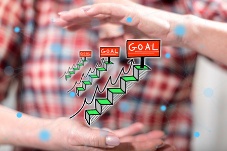 Goal concept between hands of a woman in backgroundの写真素材