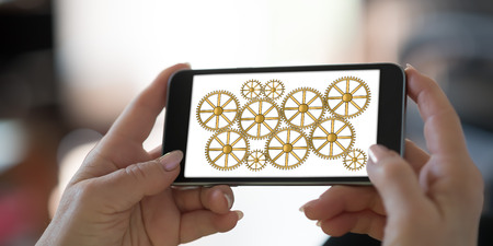 Hand holding a smartphone with teamwork concept