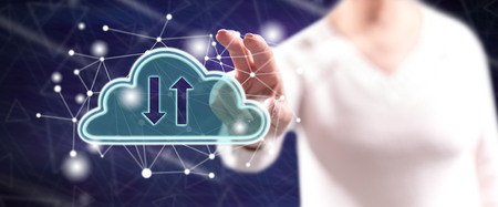Woman touching a cloud networking concept on a touch screen with her fingers