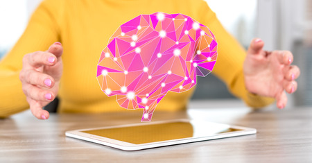 Digital tablet with artificial intelligence concept between hands of a woman in background