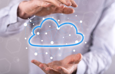 Cloud networking concept between hands of a man in background