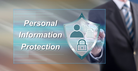 Man touching a personal information protection concept on a touch screen with a stylus penの写真素材