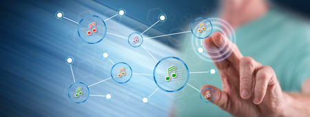 Man touching a music sharing network on a touch screen with his finger