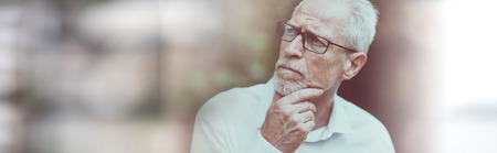 Portrait of thoughtful mature man on blurred backgroundの写真素材