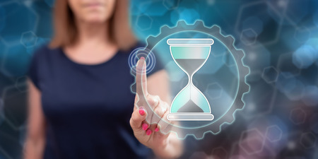 Woman touching a time management concept on a touch screen with her finger