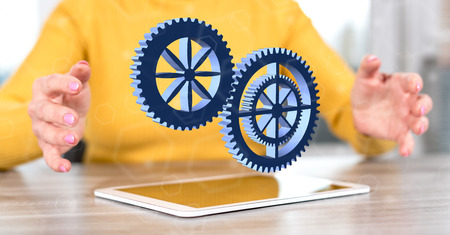 Digital tablet with teamwork concept between hands of a woman in backgroundの写真素材