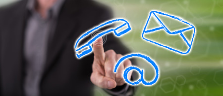 Man touching a contact concept on a touch screen with his fingerの写真素材