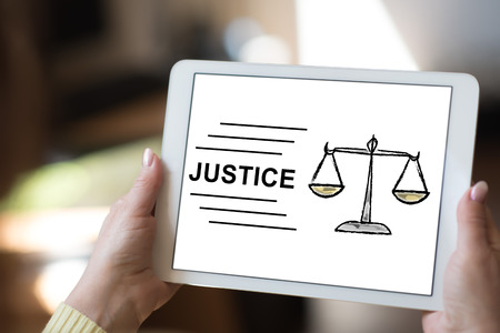Tablet screen displaying a justice conceptの写真素材