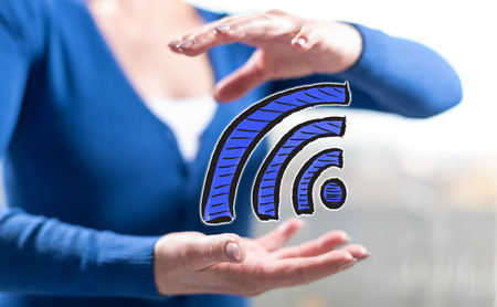 Wifi concept between hands of a woman in backgroundの写真素材