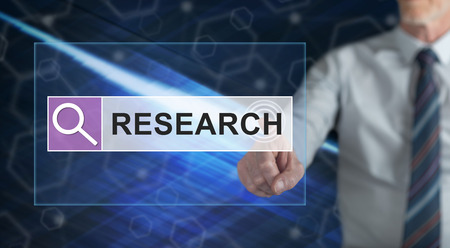 Man touching a research concept on a touch screen with his fingerの写真素材