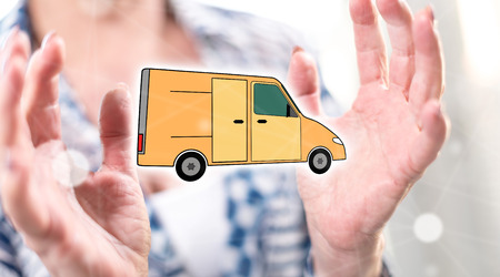 Delivery concept between hands of a woman in backgroundの写真素材