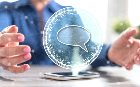 Smartphone with global communication concept between hands of a woman in background