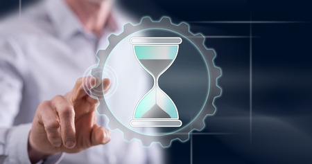 Man touching a time management concept on a touch screen with his finger