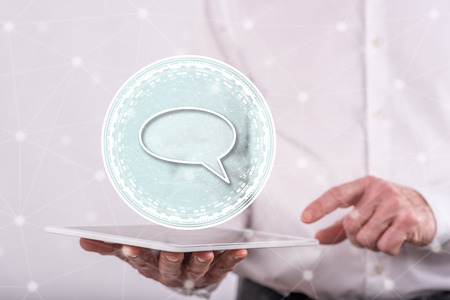 Global communication concept above a tablet held by a man in background