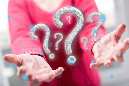 Question concept above the hands of a woman in backgroundの写真素材