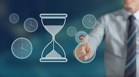 Man touching a time management concept on a touch screen with his finger