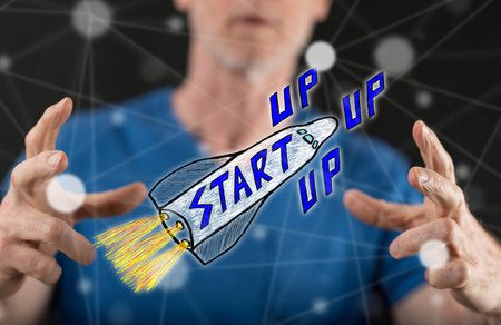 Start up concept between hands of a man in background