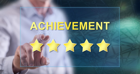 Man touching an achievement concept on a touch screen with his fingerの写真素材