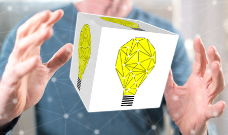 Innovation concept between hands of a man in backgroundの写真素材