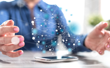 Smartphone with global connection concept between hands of a woman in backgroundの写真素材