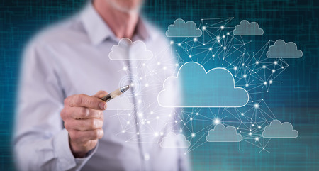 Man touching a cloud networking concept on a touch screen with a penの写真素材