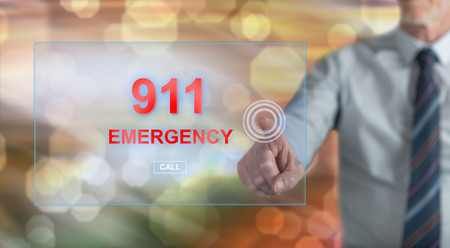 Man touching an emergency concept on a touch screen with his fingerの写真素材