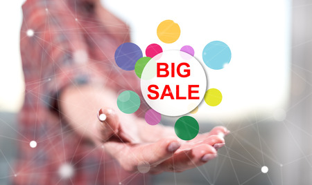 Big sale concept above the hand of a woman in backgroundの写真素材