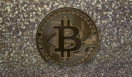 Bitcoin coin on golden glitter backgroundの写真素材