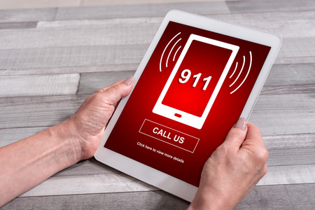 Female hands holding a tablet with emergency conceptの写真素材