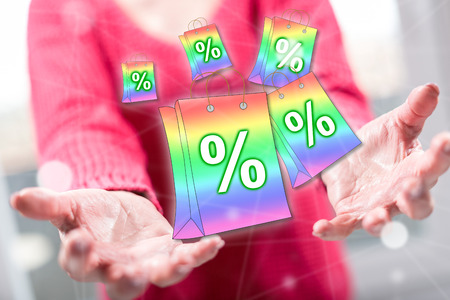 Sales and discounts concept above the hands of a woman in backgroundの写真素材