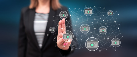 Woman touching a photo sharing concept on a touch screen with her fingersの写真素材