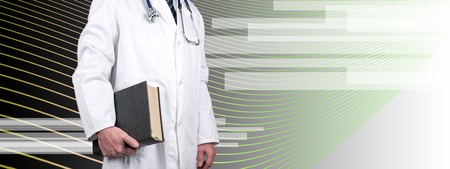 Doctor holding a book on abstract backgroundの写真素材