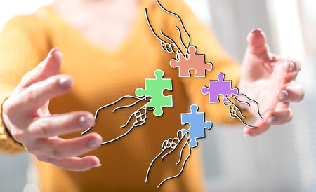 Teamwork concept between hands of a woman in backgroundの写真素材