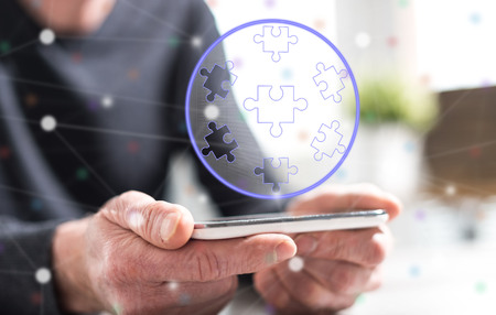 Hands of man holding a smartphone with teamwork concept