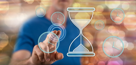 Man touching a time management concept on a touch screen with his finger