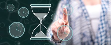 Woman touching a time management concept on a touch screen with her finger