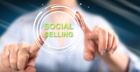 Woman touching a social selling concept on a touch screen with her fingersの写真素材