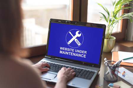 Laptop screen displaying a website maintenance conceptの写真素材