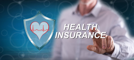 Man touching a health insurance concept on a touch screen with his fingerの写真素材