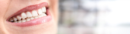 Beautiful smile of young woman on blurred backgroundの写真素材