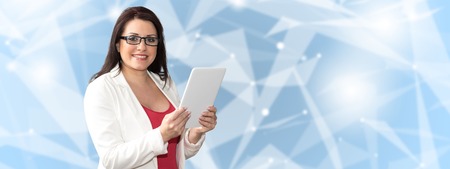 Portrait of businesswoman using digital tablet on abstract background