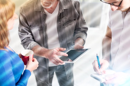 Coworkers having a business discussion in office, light effectの写真素材