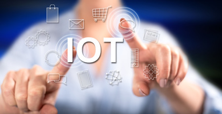 Woman touching an iot concept on a touch screen with her fingersの写真素材