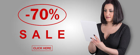 Woman using digital tablet with sale concept on backgroundの写真素材