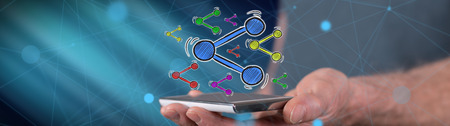Share concept above a smartphone held by a man