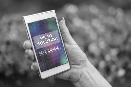 Female hand holding a smartphone with right solution conceptの写真素材
