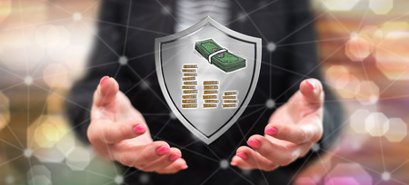 Money protection concept above the hands of a woman in backgroundの写真素材