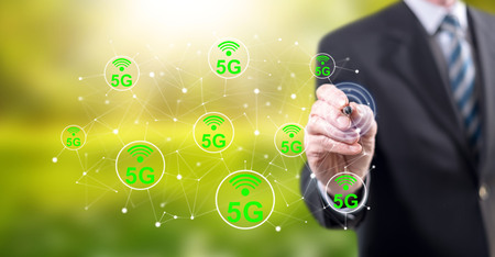 Man touching a 5g concept on a touch screen with a stylus pen