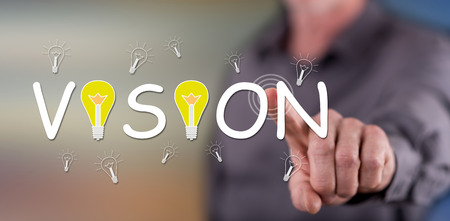 Man touching a vision concept on a touch screen with his finger