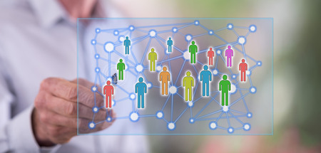 Man touching a social network concept on a touch screen with a pen